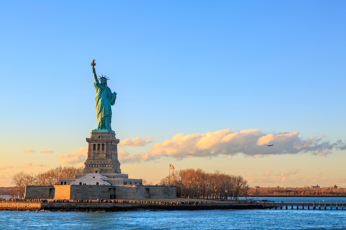 Statue of liberty horizontal during sunset in New York City, NY, USA